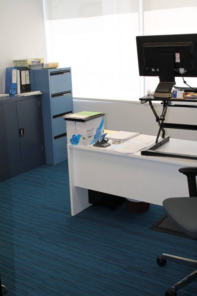 Briscoes HQ Morningside: Grey carpet in the open-plan office and grey timber-look planks in the kitchen and corridor