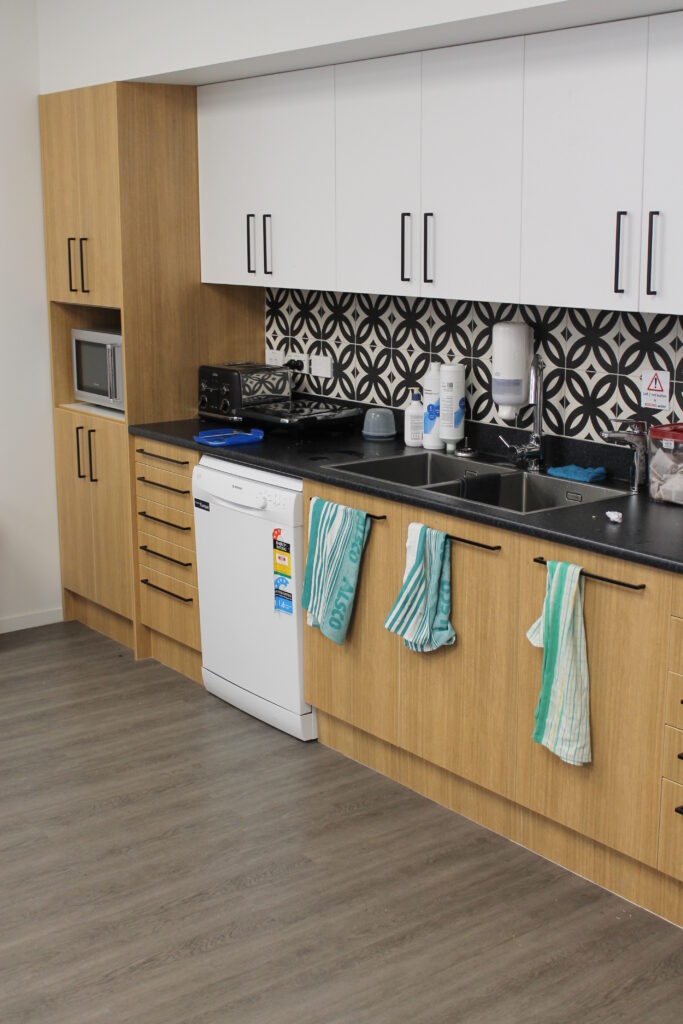 Briscoes HQ Morningside: Grey carpet in the open-plan office and grey timber-look planks in the kitchen and corridor