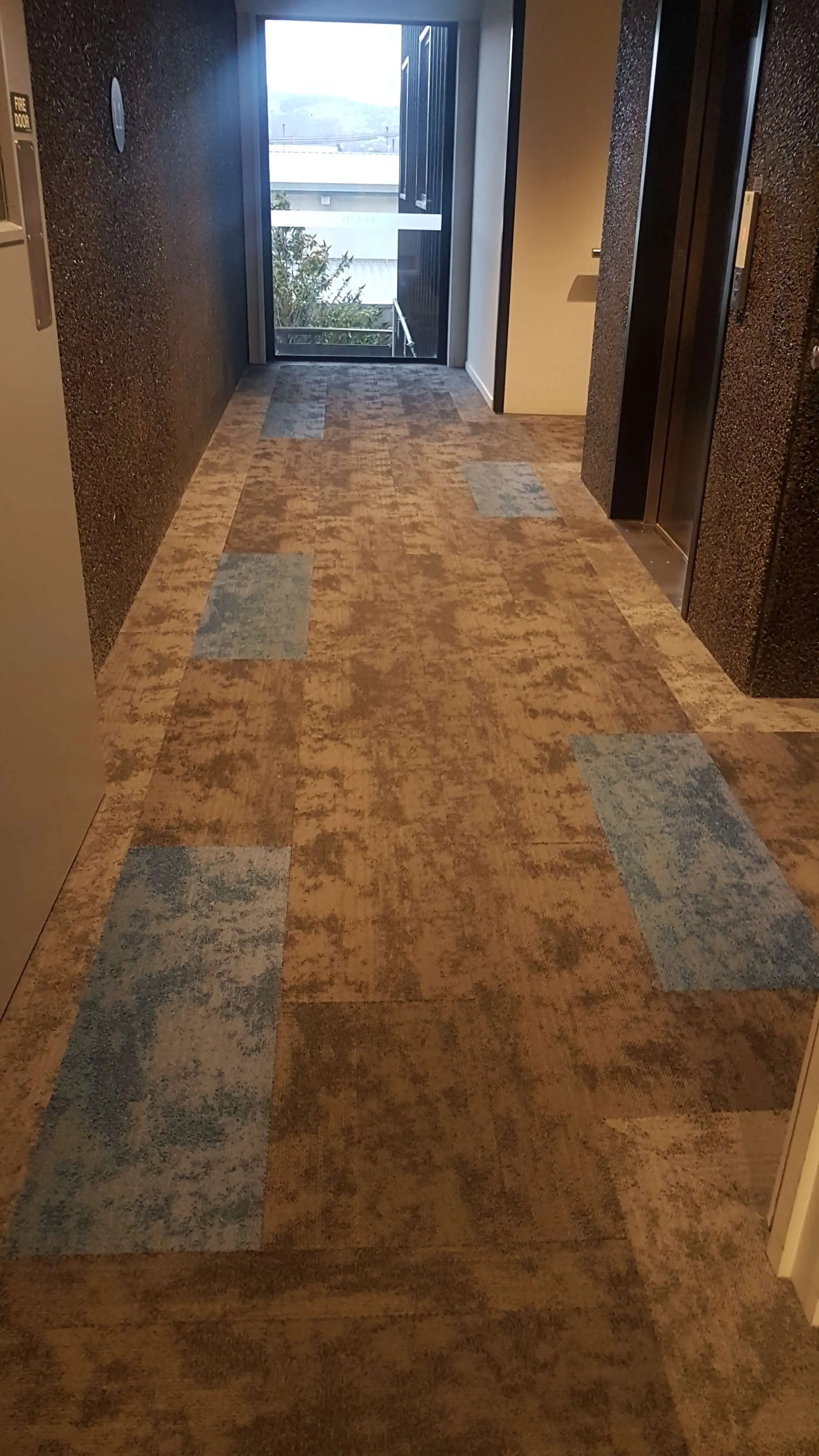 Quest Apartments: Timber-look flooring in the apartments and patterned carpet in the corridor