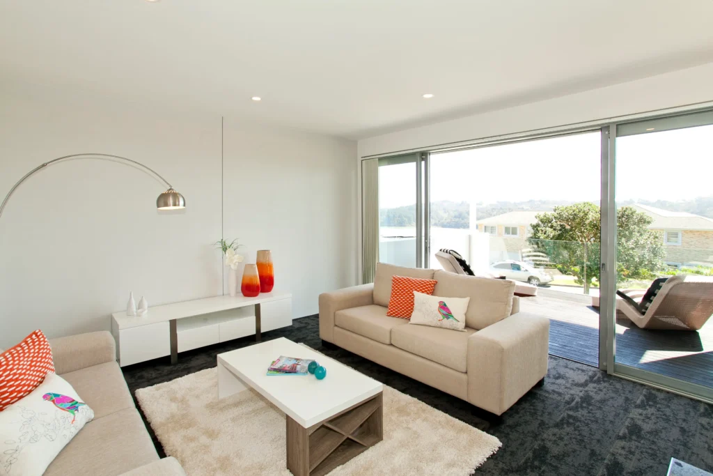 Kittiwake: Dark carpet in a bedroom with pale timber-look floor in the living area