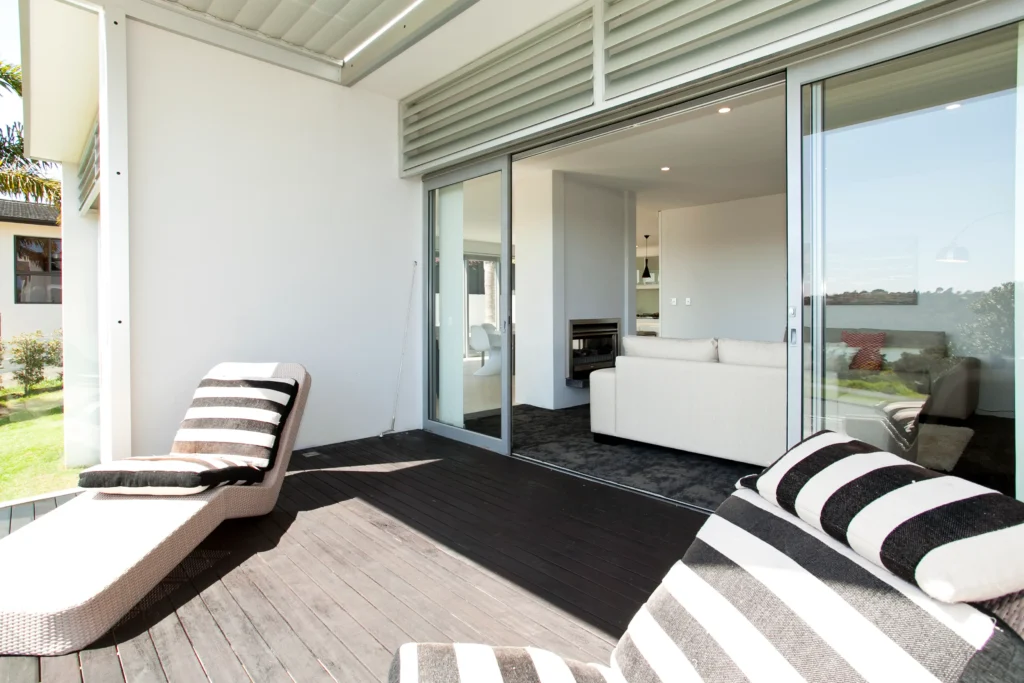 Kittiwake: Dark carpet in a bedroom with pale timber-look floor in the living area