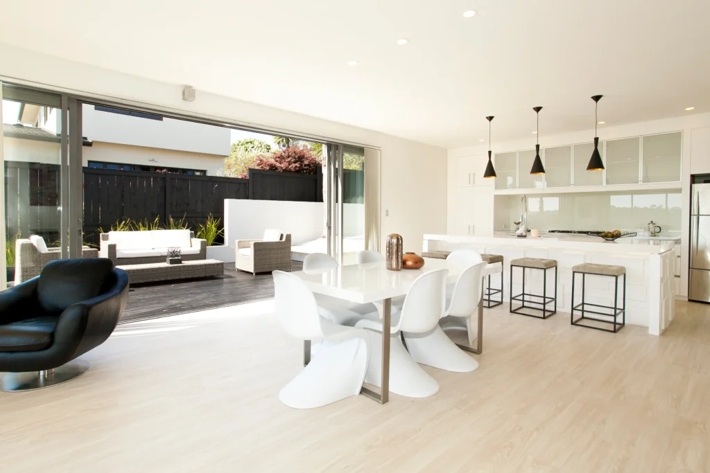 Kittiwake: Dark carpet in a bedroom with pale timber-look floor in the living area