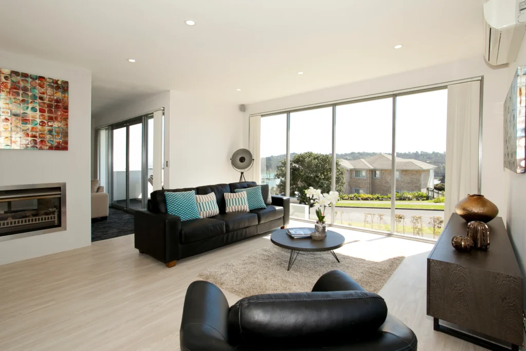 Kittiwake: Dark carpet in a bedroom with pale timber-look floor in the living area