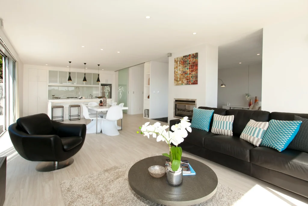 Kittiwake: Dark carpet in a bedroom with pale timber-look floor in the living area