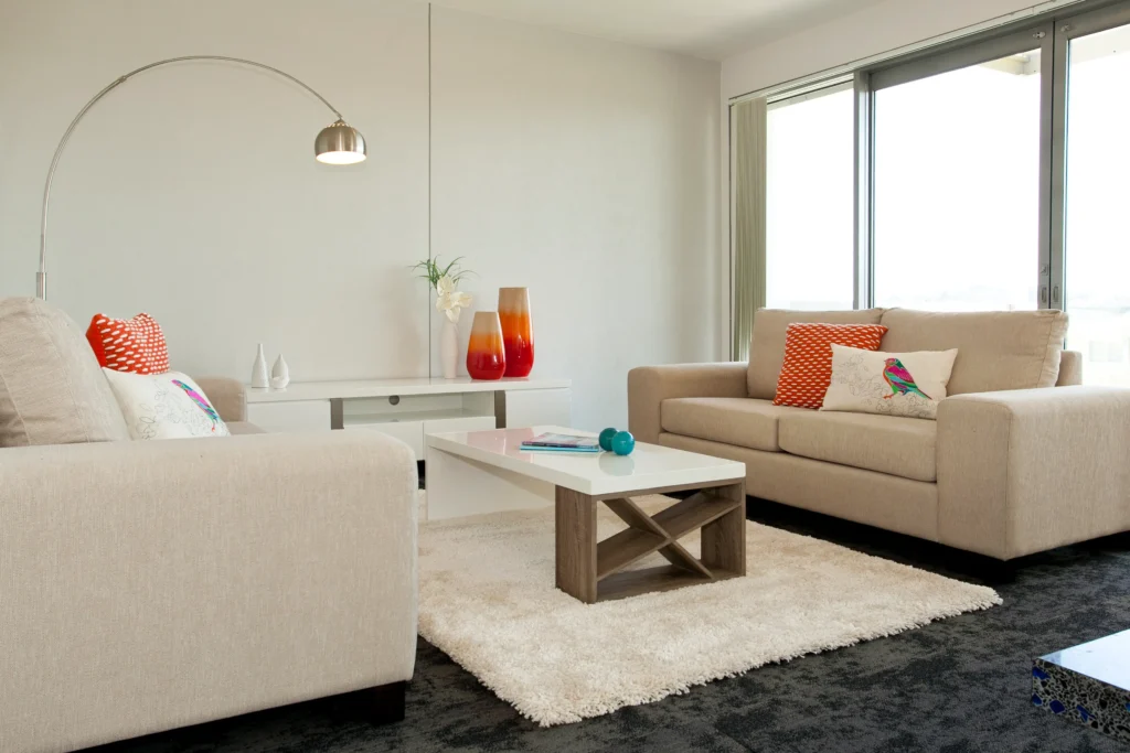 Kittiwake: Dark carpet in a bedroom with pale timber-look floor in the living area