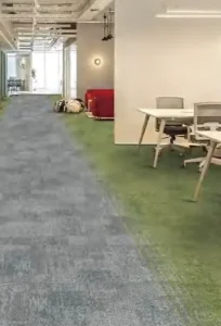 Corridor with grey and green carpet tile flooring leading to a meeting room