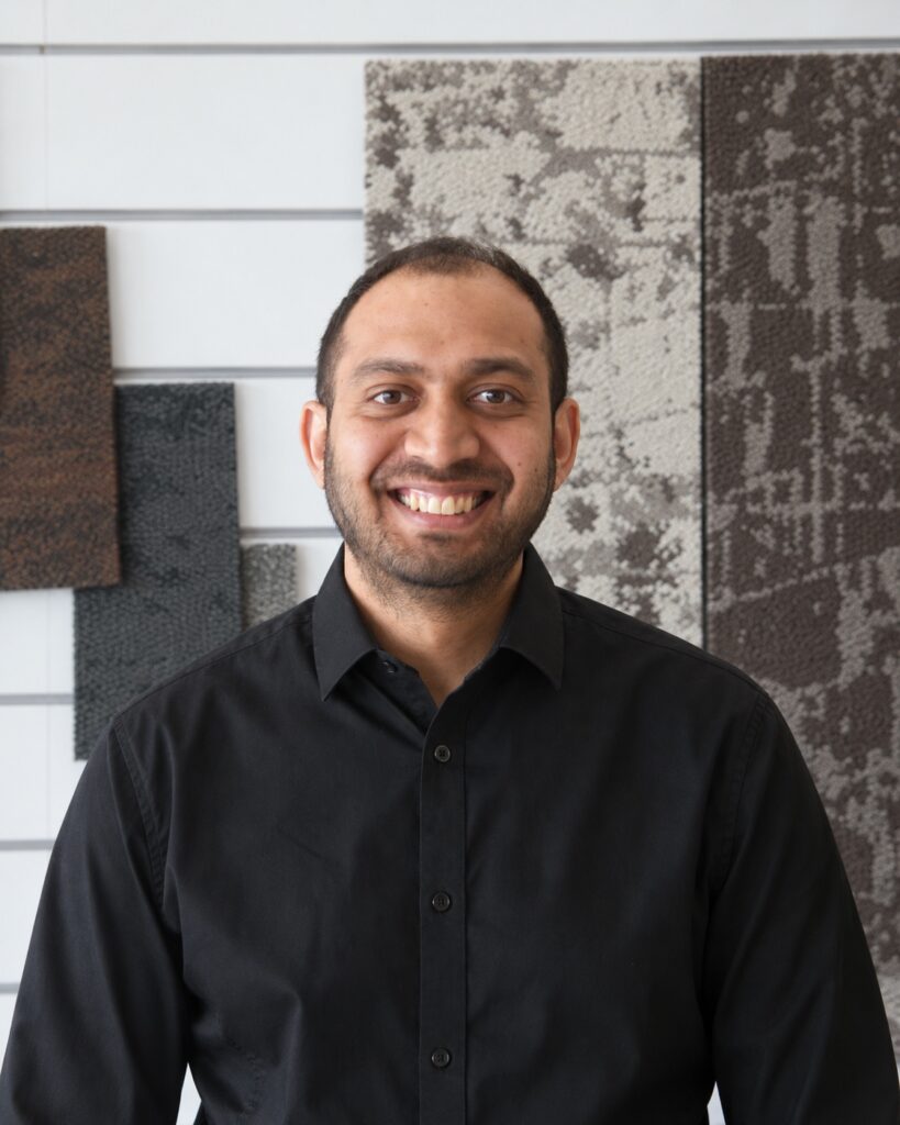 George, Project Floors team member, smiling in a black shirt